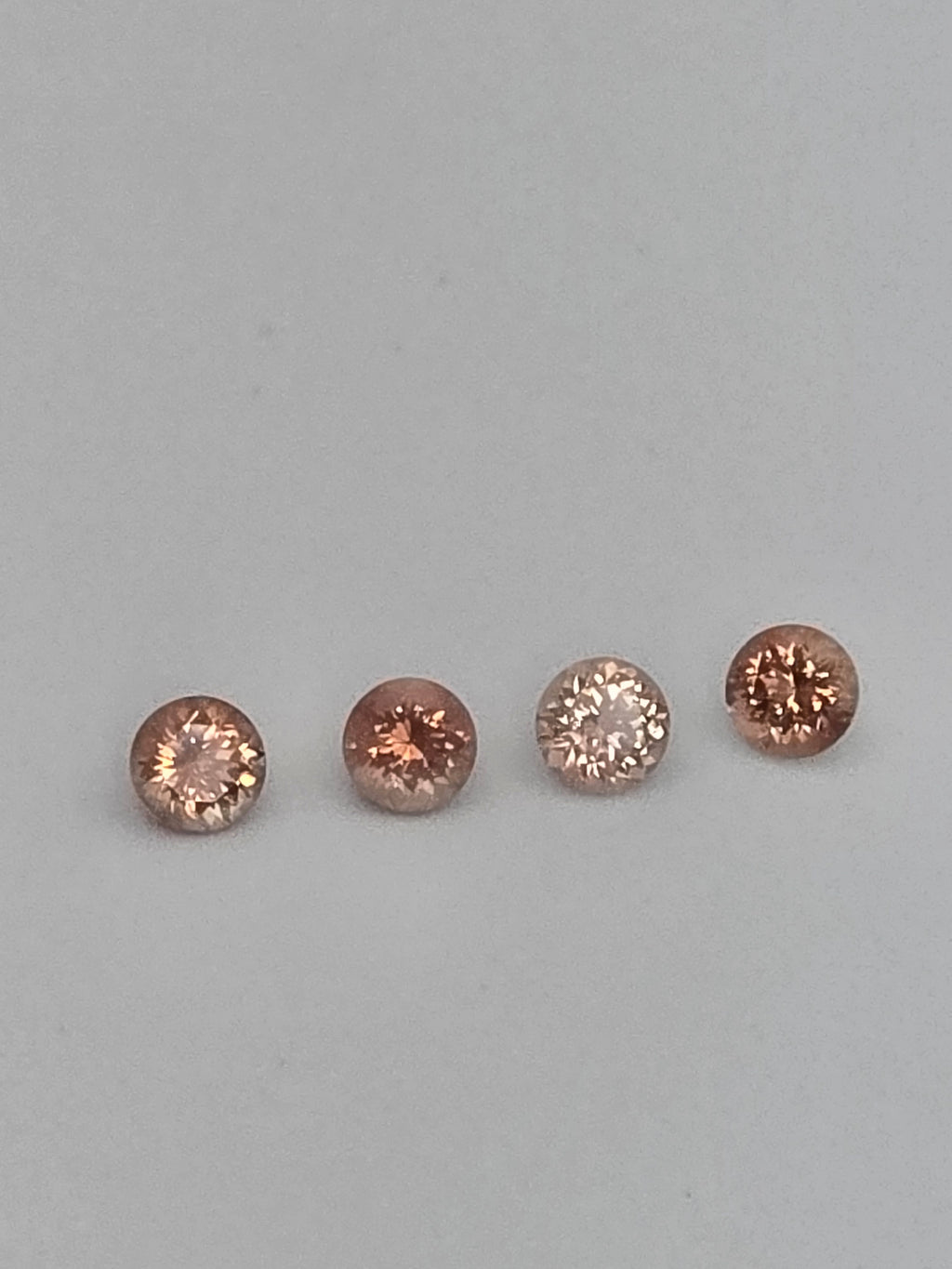Lot of 4 Oregon Sunstones – 6mm Round, Strong Schiller & Flash (2.8 Carats Total)